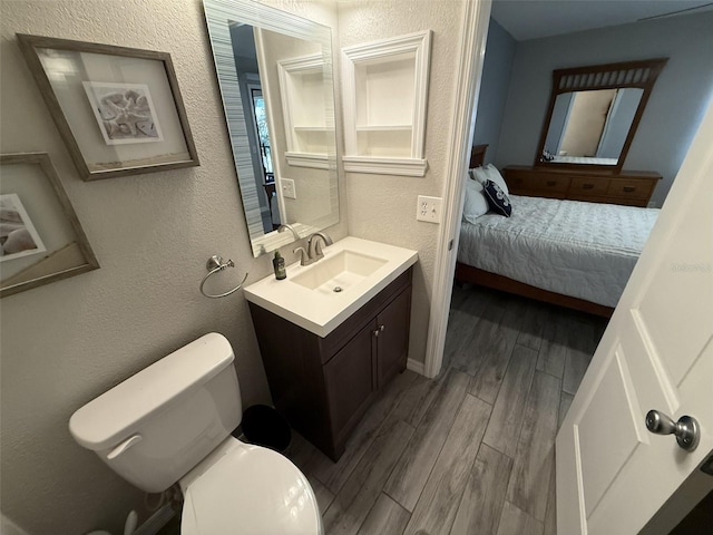 bathroom featuring hardwood / wood-style floors, vanity, and toilet