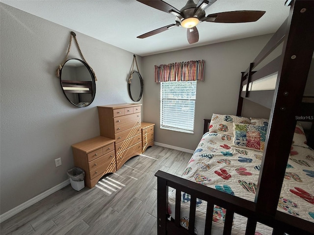 bedroom featuring ceiling fan and light hardwood / wood-style flooring