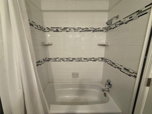 bathroom with shower / bath combo with shower curtain