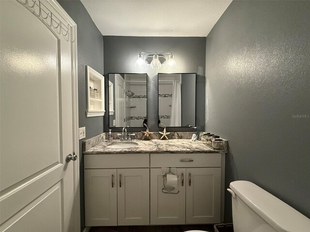 bathroom featuring vanity and toilet