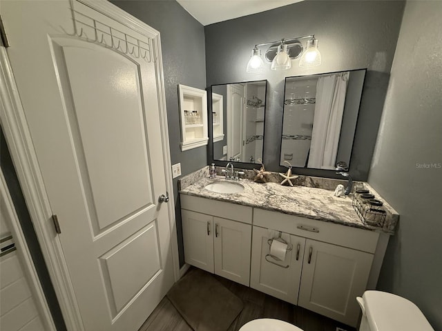 bathroom featuring vanity and toilet