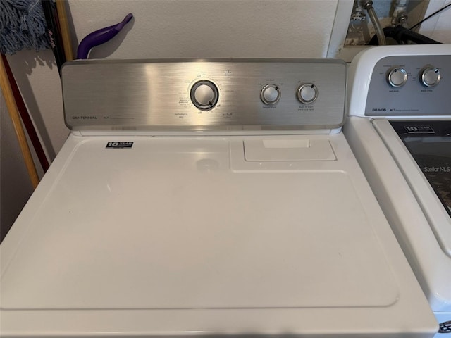 room details featuring washer and clothes dryer