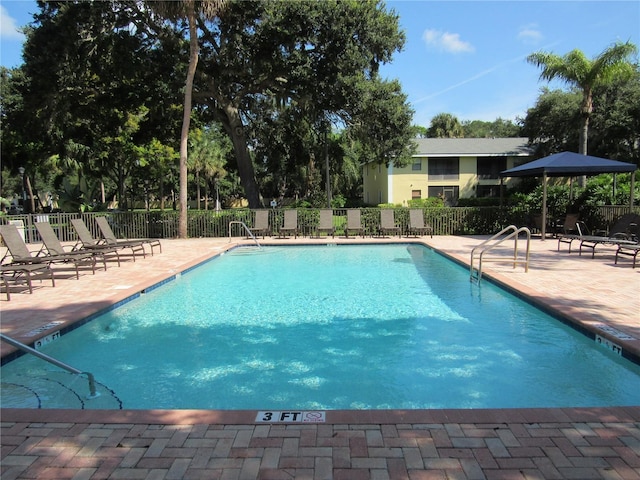 view of swimming pool with a patio area