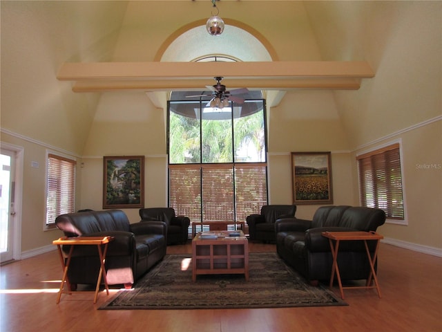 living room featuring ceiling fan, beamed ceiling, high vaulted ceiling, and hardwood / wood-style flooring