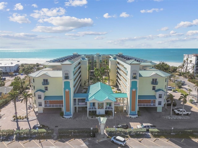 birds eye view of property with a water view and a view of the beach