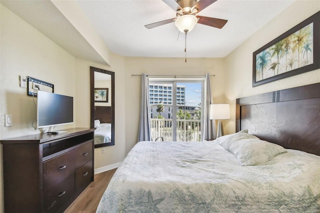 bedroom with access to outside, ceiling fan, and dark hardwood / wood-style flooring