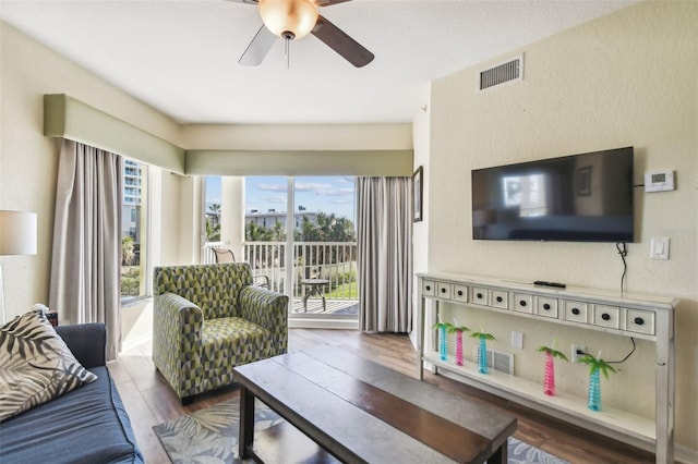 living room with ceiling fan and hardwood / wood-style floors