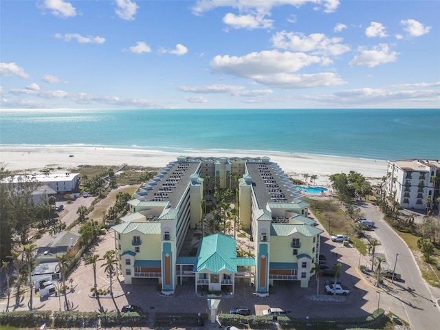 drone / aerial view featuring a beach view and a water view