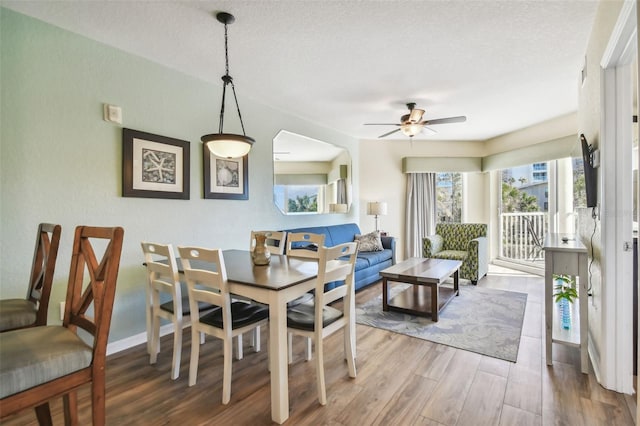 12000 Gulf Blvd Unit 208-S, Treasure Island, FL 33706 - dining area with wood finished floors, ceiling fan, and a textured ceiling