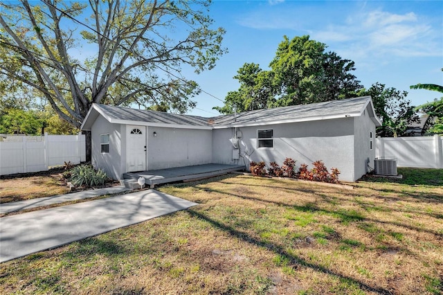 single story home featuring a patio area, central air condition unit, and a front lawn