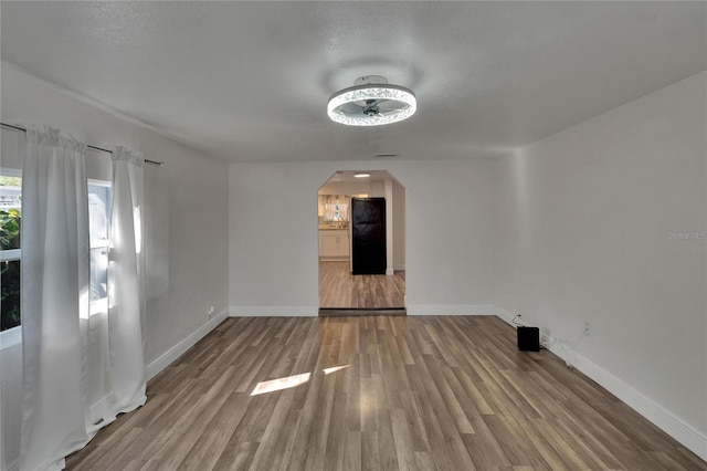 spare room with hardwood / wood-style floors