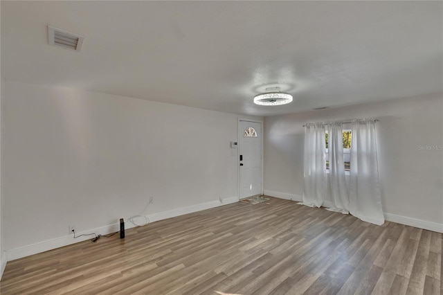 empty room with light hardwood / wood-style flooring