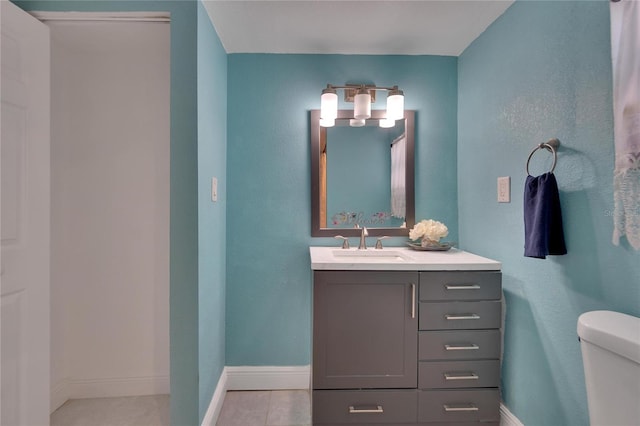 bathroom featuring tile patterned floors, vanity, and toilet