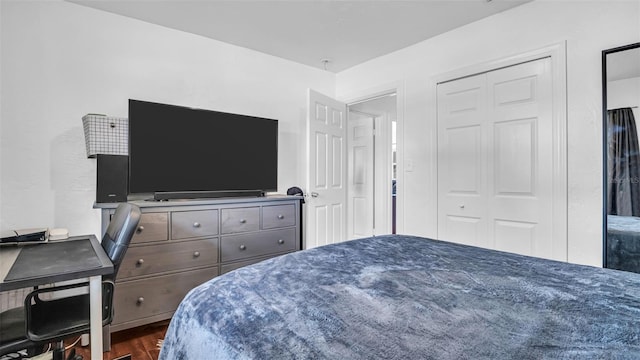 bedroom featuring a closet and dark wood-type flooring