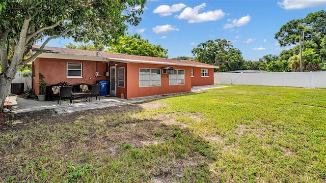 back of house featuring a patio, central AC, and a lawn