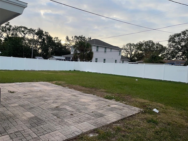 yard at dusk with a patio