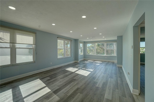 empty room featuring hardwood / wood-style floors and a textured ceiling