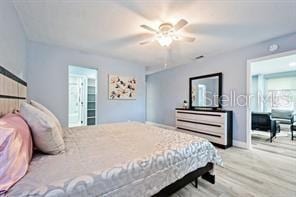 bedroom with ceiling fan and light hardwood / wood-style floors