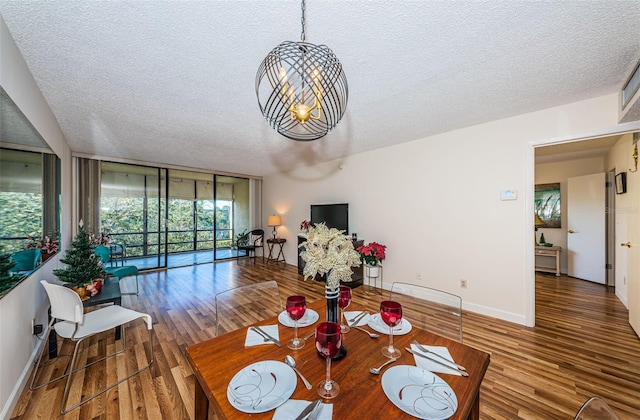 dining space with floor to ceiling windows, hardwood / wood-style floors, and a textured ceiling