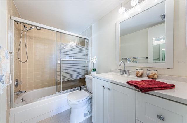 full bathroom with vanity, enclosed tub / shower combo, and toilet