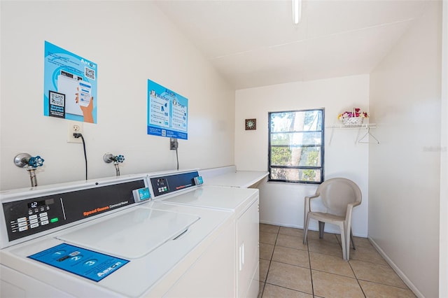 laundry room featuring separate washer and dryer and light tile patterned flooring