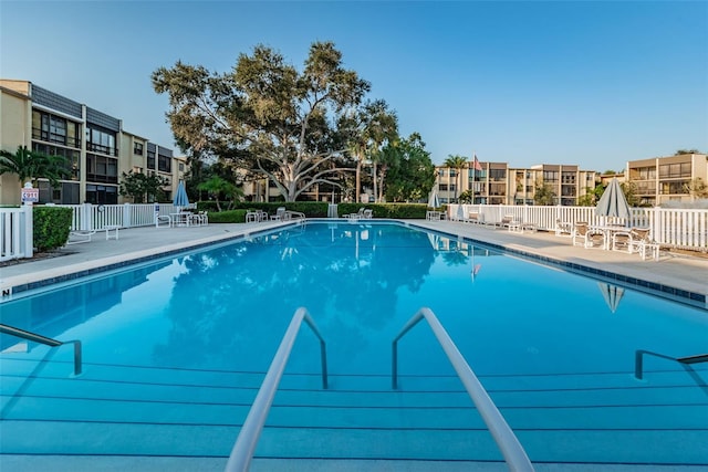 pool featuring a patio area, a residential view, and fence