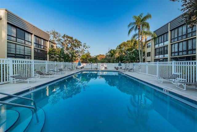 pool featuring a patio area and fence