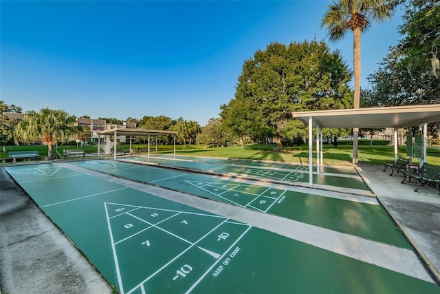 surrounding community featuring a lawn and shuffleboard