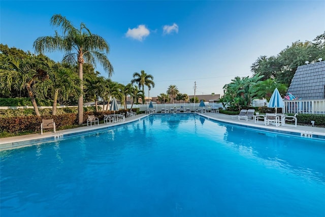 community pool featuring a patio area and fence