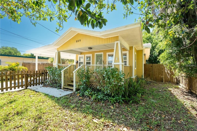 back of house featuring covered porch