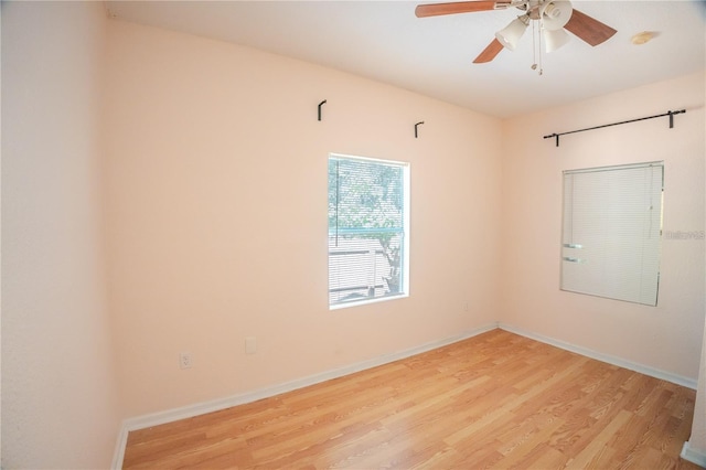 empty room featuring ceiling fan and light wood-type flooring