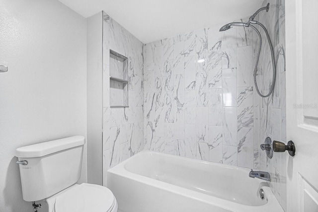 bathroom featuring toilet and tiled shower / bath