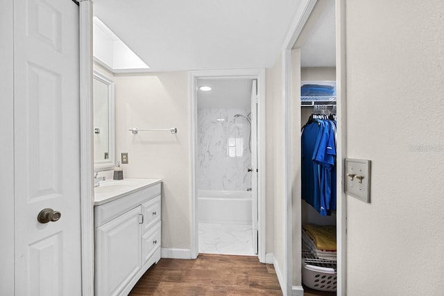 bathroom featuring vanity, tiled shower / bath combo, and hardwood / wood-style flooring