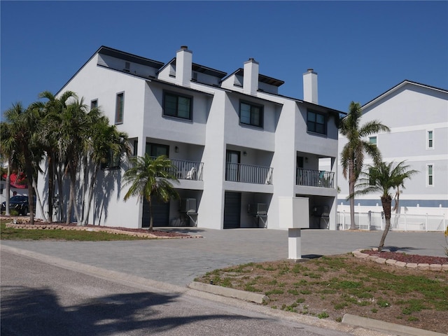 view of building exterior with driveway and a garage