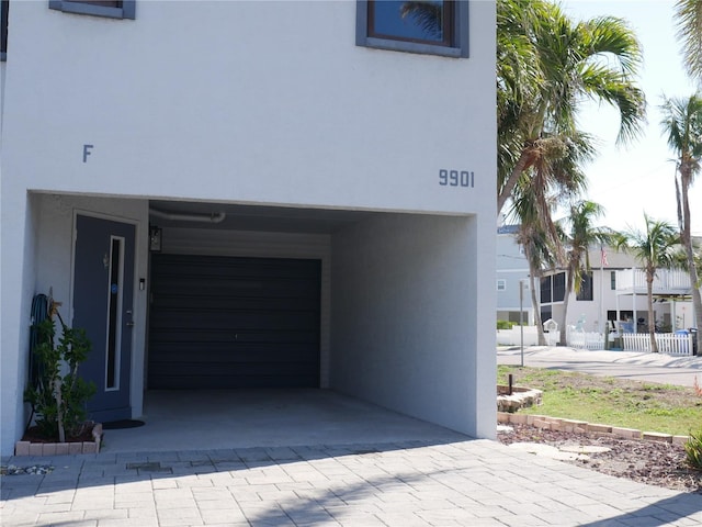 details with decorative driveway and stucco siding