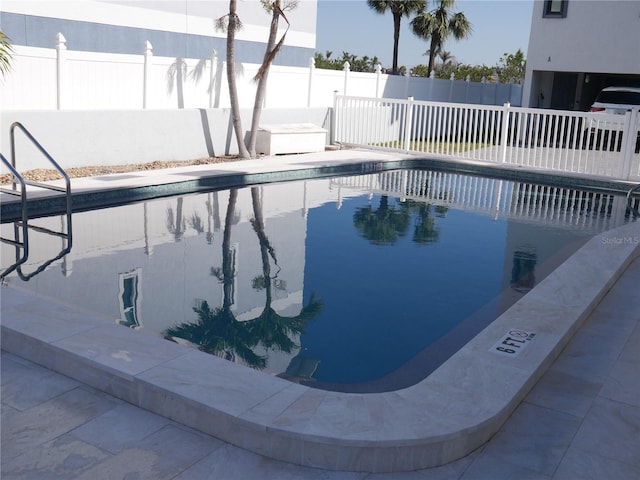 community pool featuring a fenced backyard