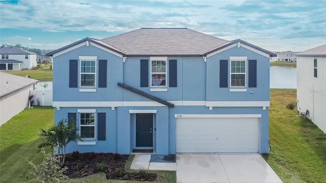 view of front of home with a front yard and a garage