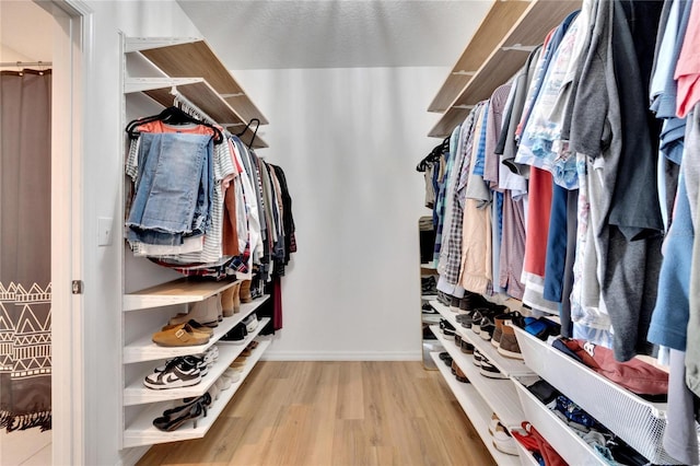 spacious closet featuring light hardwood / wood-style flooring