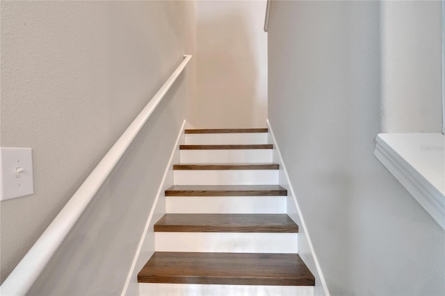 stairs featuring hardwood / wood-style floors