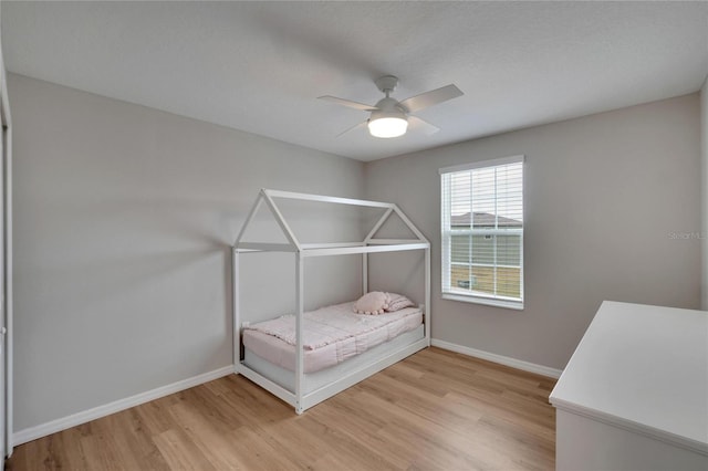 unfurnished bedroom with a textured ceiling, light hardwood / wood-style flooring, and ceiling fan