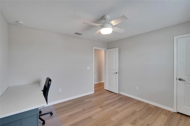 office space with ceiling fan, light wood-type flooring, and a textured ceiling