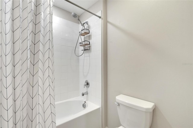 bathroom featuring shower / bath combo and toilet