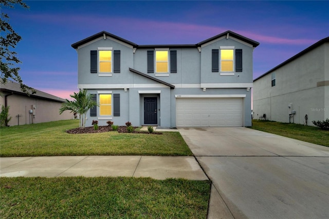 view of front property with a lawn and a garage