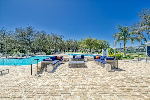 view of swimming pool with a patio area and an outdoor living space