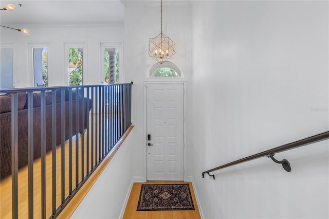 foyer featuring hardwood / wood-style flooring and a chandelier