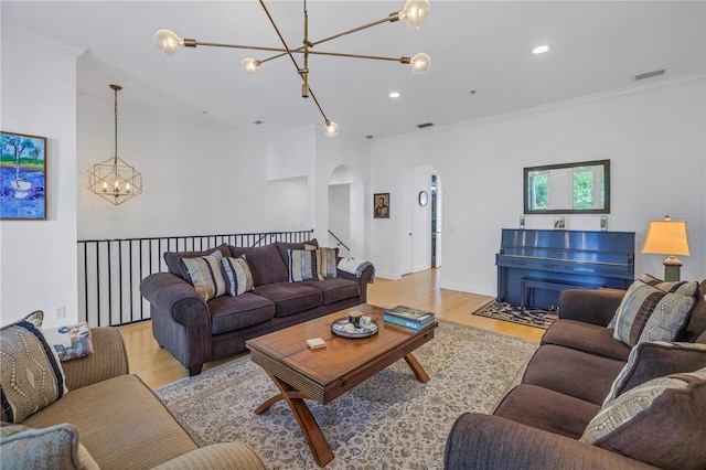 living room with light wood-type flooring and ornamental molding