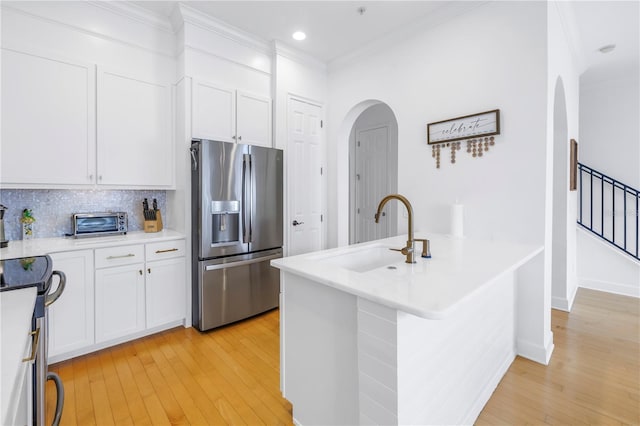 kitchen featuring backsplash, stainless steel fridge with ice dispenser, light hardwood / wood-style flooring, and white cabinetry