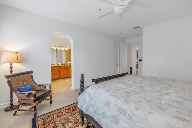 bedroom featuring ensuite bathroom, ceiling fan, and light hardwood / wood-style flooring