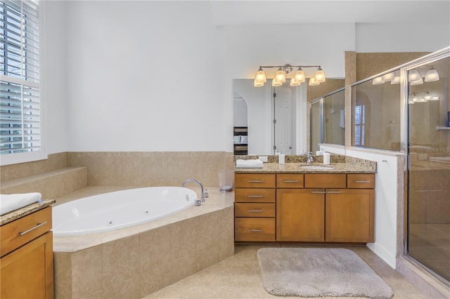 bathroom with tile patterned flooring, vanity, and separate shower and tub