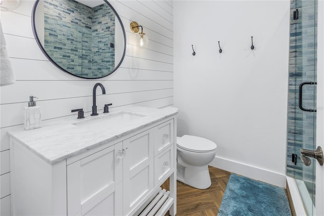 bathroom with walk in shower, parquet floors, vanity, and toilet